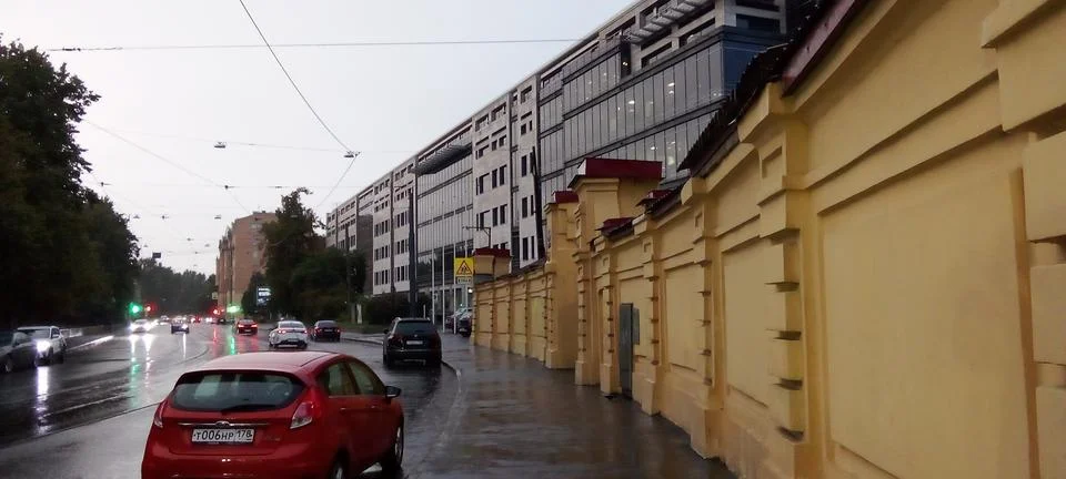 View from the side of the road of a large building and rainy weather Stock Photos