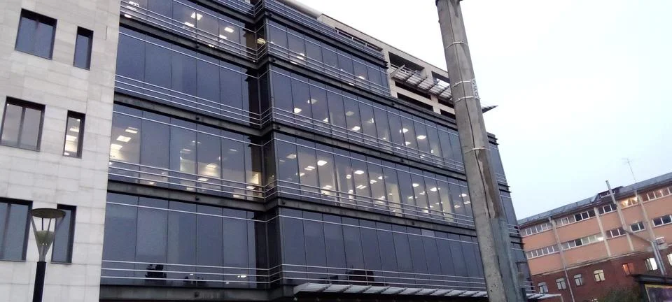 View from the side of the road of a large building and rainy weather Stock Photos