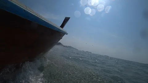 View side of sailing boat moving over the sea water splashing to camera. Stock Footage 87957156