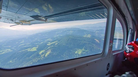 View from the side window of an airplane for the jump of parachutists. Video stock 128736693