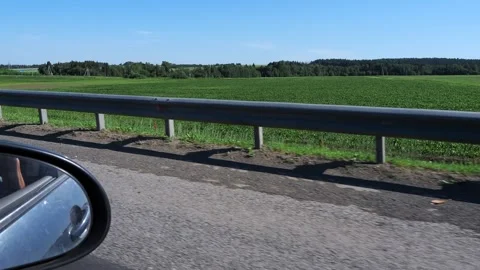 View from the side window of a car moving along the highway to a beautiful su Stock Footage 288175433