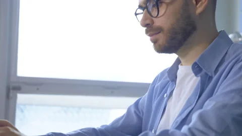 View from the Side A Young Thoughtful Man Working On A Startup Project Online Stock Footage 146318989