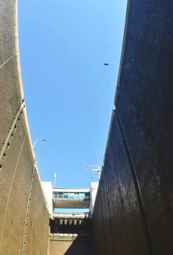 View up the sides of a river-lock to the sky. Stock Photos