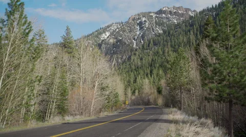 A view of a Sierra Nevada Mountain range road in spring Stock Footage 62632087