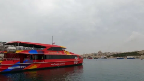 View of a sightseeing touristic ship in Sliema bay, Malta, in a cloudy day Stock Footage 153804055