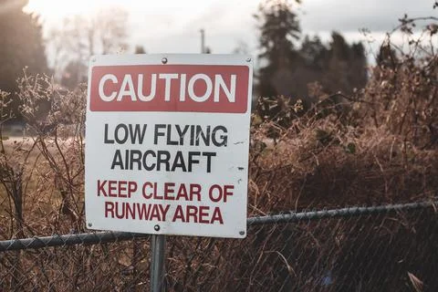 View of sign Caution Low Flying Aircraft at local airport in Courtenay Stock Photos
