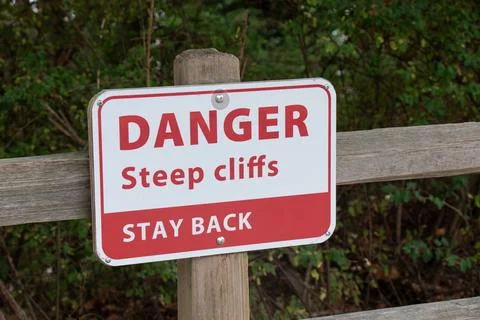 View of sign Danger Steep Cliffs Stay Back on the Wreck Beach in Vancouver Stock Photos