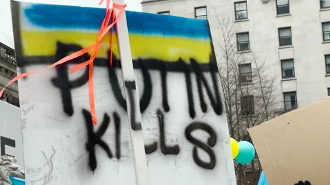 View of sign Putin Kills during the rally against invasion of Ukraine Stock Footage 171075394