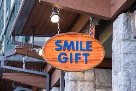 View of sign Smile Gift Store in Whistler Village Stock Photos