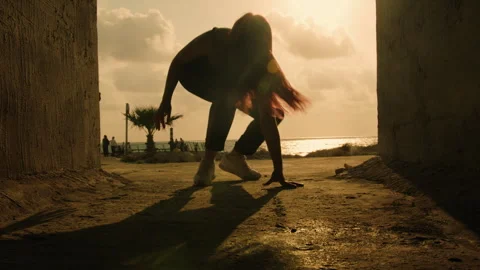 View of silhouette dancer from ground in passage way Stock Footage 275106232