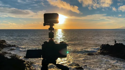 View of the silhouette of two cameras shooting the amazing sunset Stock Footage 171164951
