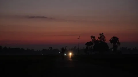 View of a silhouetted road at dawn with trees in Bangladesh. Video stock 335552602