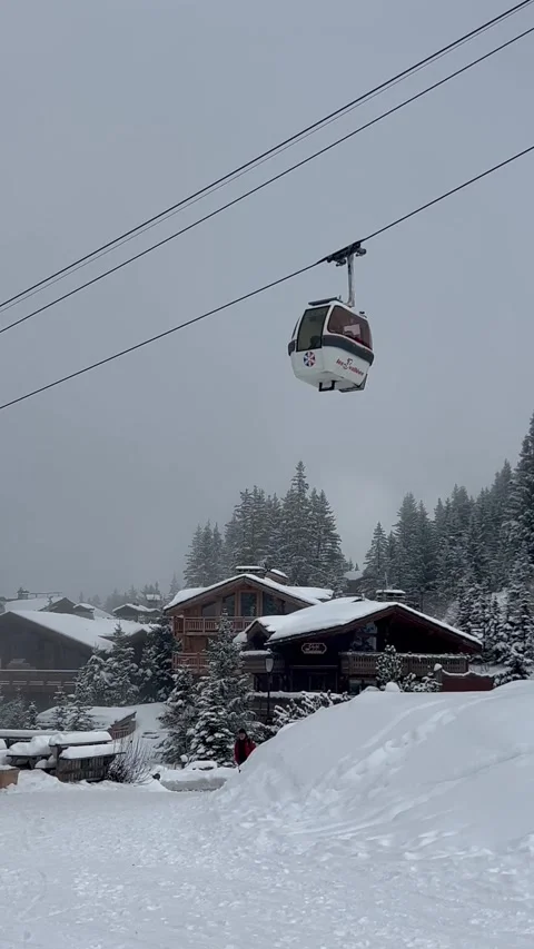 View of ski lifts, white gondolas in Courchevel ski resort, French alps. Stock Footage 336928969