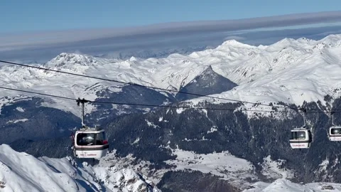 View of ski lifts, white gondolas in Courchevel ski resort, French alps Stock Footage 337004214