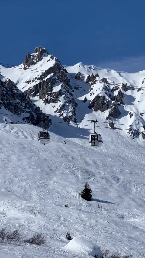 View of ski lifts, white gondolas in Courchevel ski resort, French alps, France Stock Footage 337052195