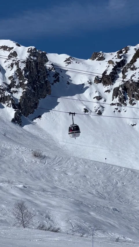 View of ski lifts, white gondolas in Courchevel ski resort, French alps Stock Footage 337052199