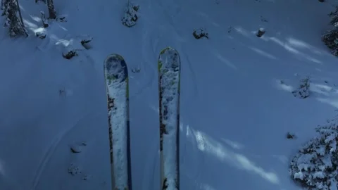 View of ski tips hanging above a snow covered mountain slope. Stock Footage 342341652