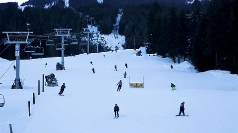 A view of skiers coming down the hill as seen from Whistler village. Stock Footage 101775288