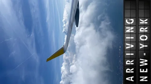 View of the sky from an airplane and a display board with arriving in New York Stock Footage 194508235