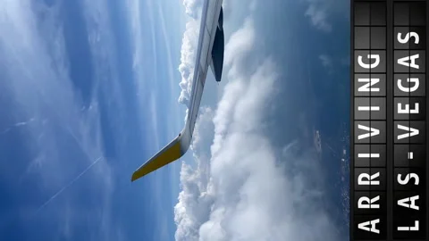 View of the sky from an airplane and a display board with arriving in Las Vegas Stock Footage 194816516
