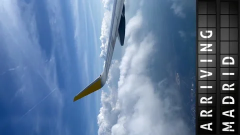 View of the sky from an airplane and a display board with arriving in Madrid Stock Footage 194816531