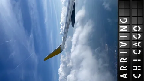 View of the sky from an airplane and a display board with arriving in Chicago Stock Footage 194816533