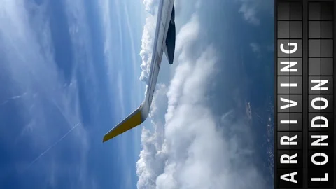 View of the sky from an airplane and a display board with arriving in London Stock Footage 194816534