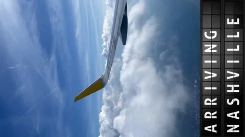 View of the sky from an airplane and a display board with arriving in Nashville Stock Footage 195993133