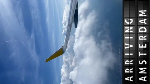 View of the sky from an airplane and a display board with arriving in Amsterdam Stock Footage 196867307