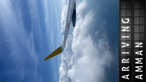 View of the sky from an airplane and a display board with arriving in Amman Stock Footage 196867312