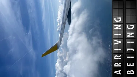 View of the sky from an airplane and a display board with arriving in Beijing Stock Footage 196867460