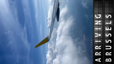 View of the sky from an airplane and a display board with arriving in Brussels Stock Footage 197330517