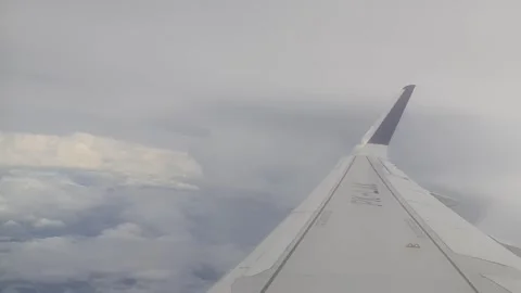 The view of the sky and clouds from the airplane window is slightly cloudy 스톡 동영상 268956117