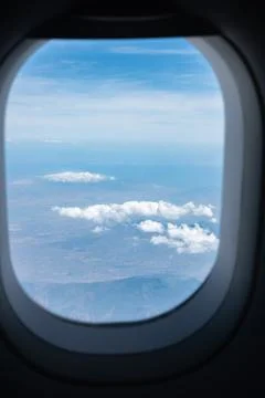 View of the sky and clouds from the airplane porthole window. Travel, vacat.. Stock Photos