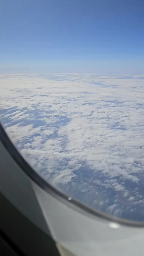View of the sky and the ground from a plane window while traveling. Stock Footage 305791089