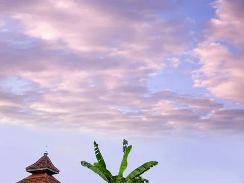 View of the sky and there is a prayer room on it there is also a banana tree Stock Photos