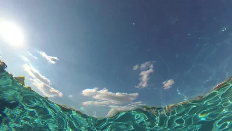 View of the sky from the bottom of the pool through the water. Underwater Stock Footage 163088289