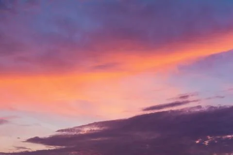 View of the sky in the evening at sunset with a dark cloud and bright orange  Stock Photos