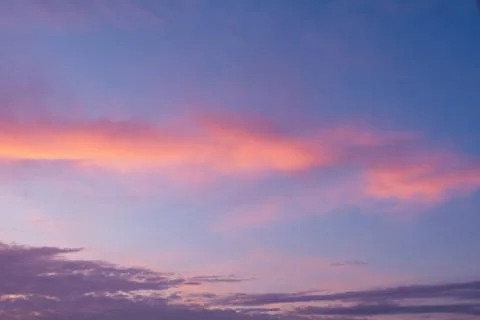 View of the sky in the evening at sunset with a dark cloud and bright orange  Stock Photos