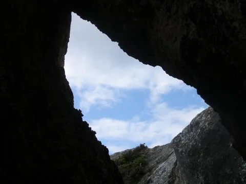 View of the sky from inside a cave Stock Photos