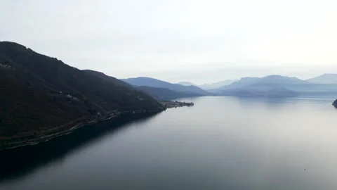 View from the sky of Lake Maggiore surrounded by mountains Stock Footage 274301854