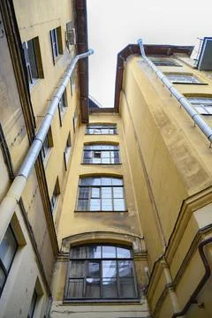 View of the sky from the narrow triangular courtyard of an apartment building Stock Photos