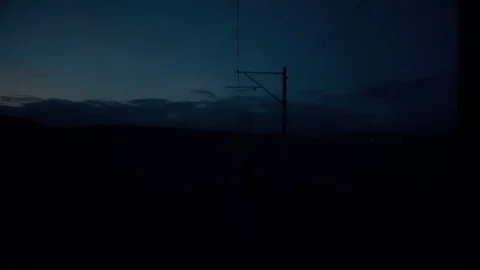 View of the sky from the rear of train at dawn Stock Footage 95700893