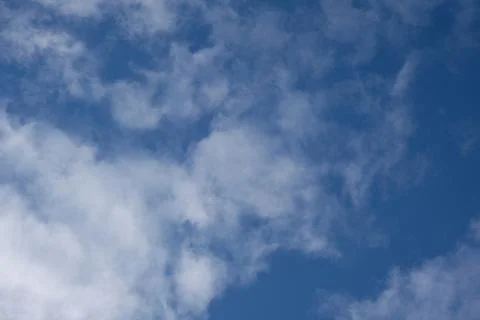 View of the sky with scattered white clouds. Concept of leisure, calm and pea Фото
