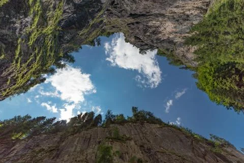 View of the sky through a gap in the rock Stock Photos