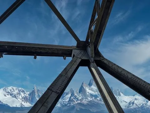 View of the sky through the iron structure of the bridge Stock Photos