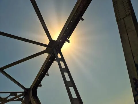 View of the sky through the iron structure of the bridge Stock Photos