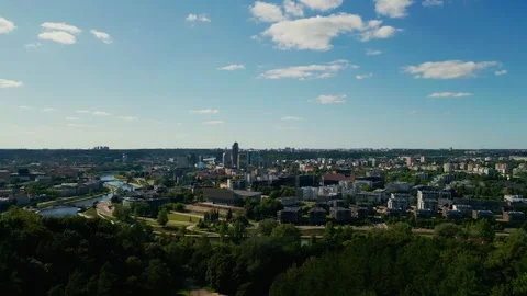 View of the skyline of Vilnius city through the trees of the park at sunset Video stock 248647814