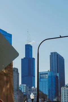 View of skyscraper with blue glass facade against clear sky in a city durin.. Fotos de archivo