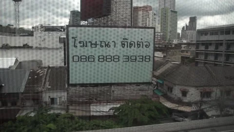 A view from a Skytrain window in Bangkok. Video stock 303105943